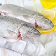 A healthy recipe for fish baked on a bed of broccoli, corn and red pepper